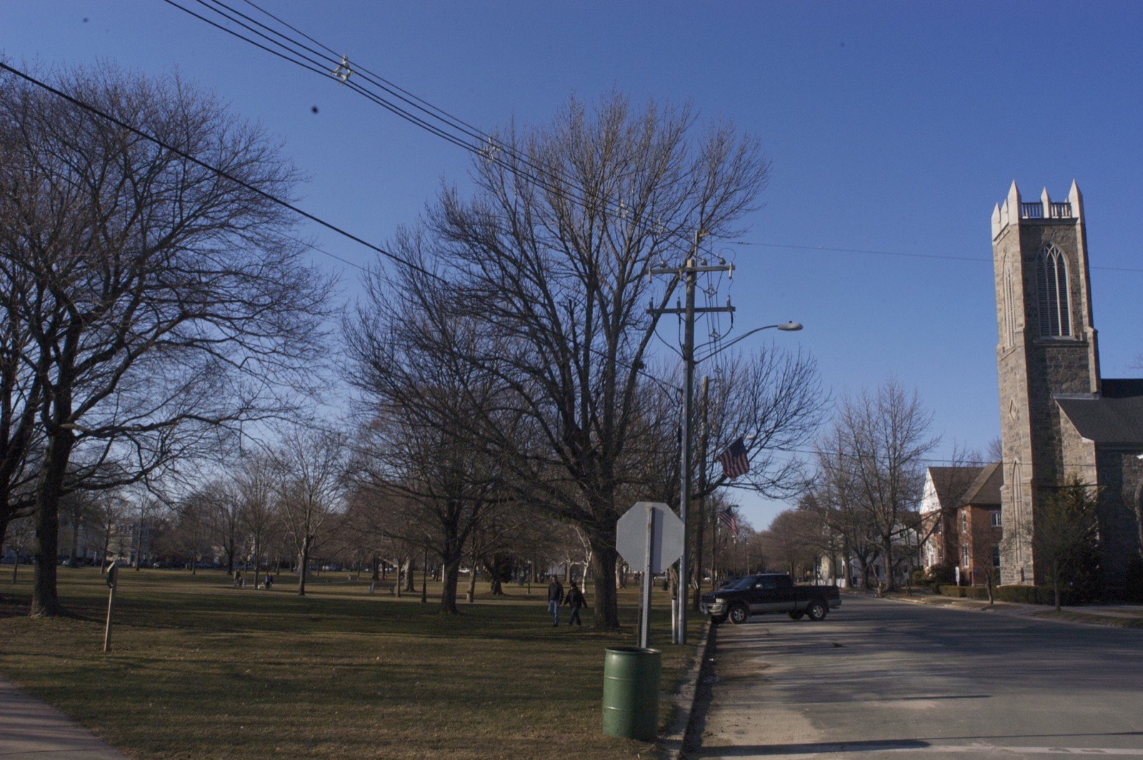 The Guilford Green with a stone church, trees, and a pickup truck parked along the street.