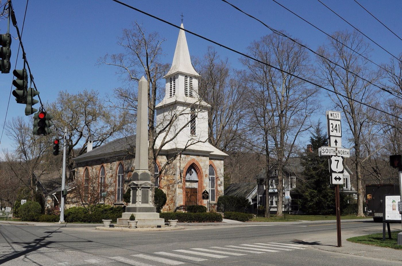 The war memorial obelisk and St. Andrew's Church in Kent, Connecticut