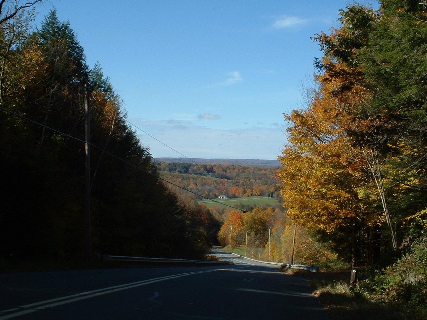 A view down Frizzell Hill Road toward farmland and forested hills in Leyden, Massachusetts, in autumn.