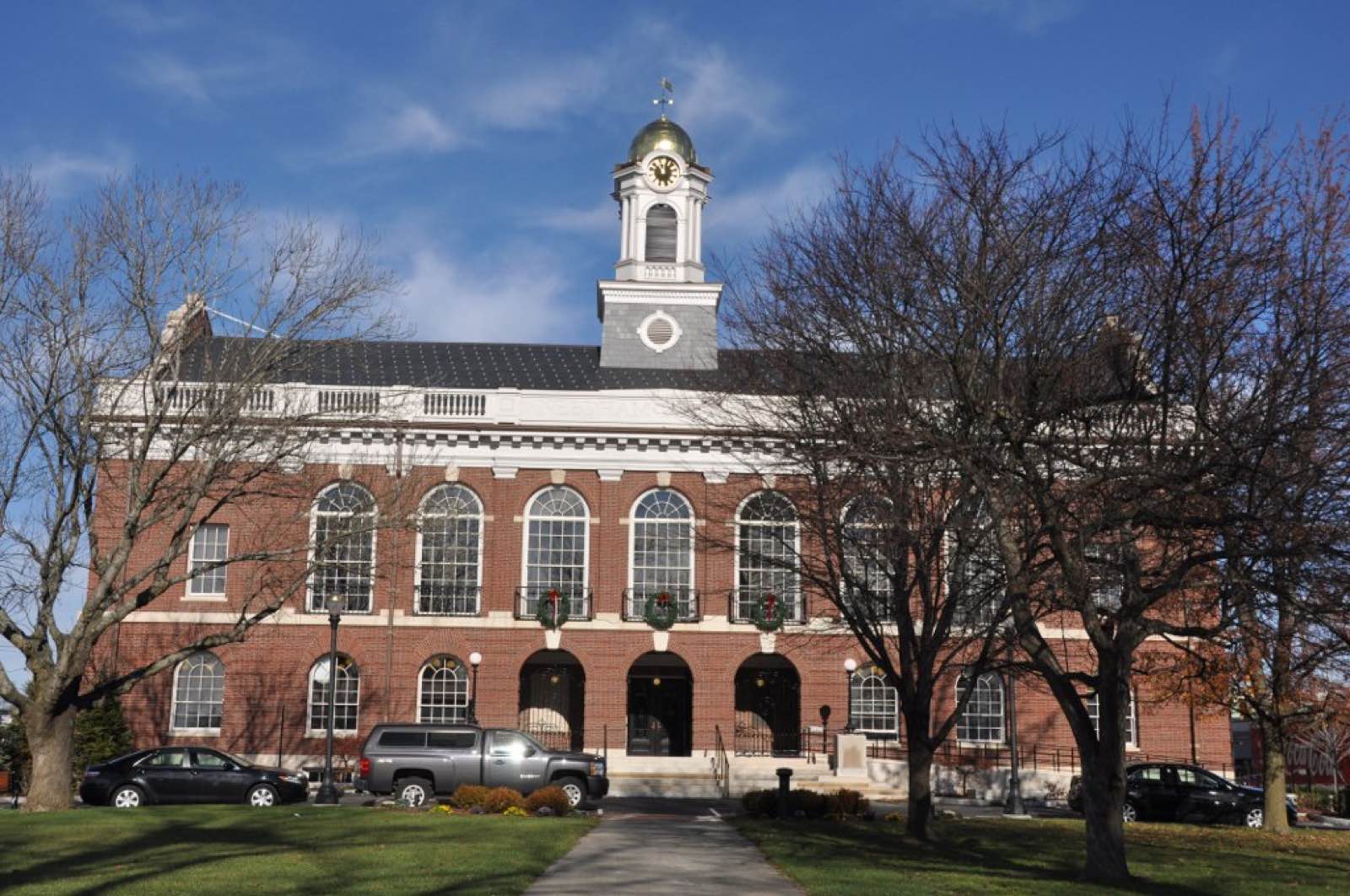 Needham Town Hall, a brick municipal building on Highland Avenue in Needham, Massachusetts.