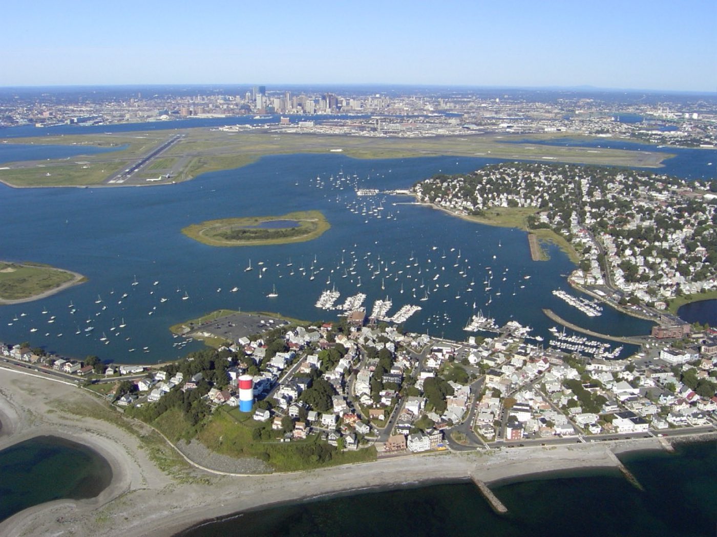 Aerial view of Winthrop, Massachusetts from the northeast, with Logan International Airport and the Boston skyline in the background.